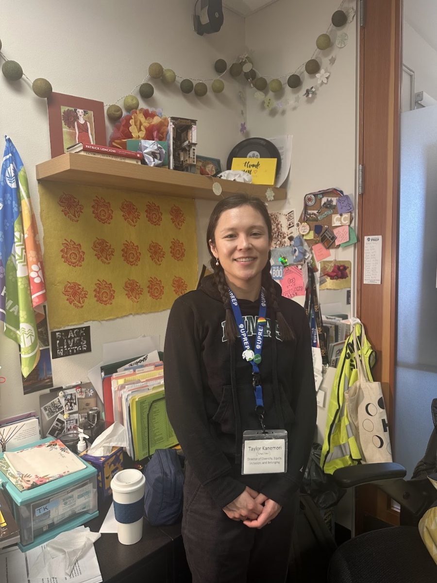 Kanemori is pictured standing in her office. DEIB work is fundamental to UPrep's culture and values. “I've seen [DEIB] shift from kind of a check box almost, to be, we have somebody who looks at that, to actually, we have a lens of this work across the whole institution.” Kanemori said.